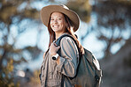 Hiking woman, portrait and smile for adventure, summer and explore forest with backpack, excited and happy. Explorer girl, woods and travel with freedom, nature vacation and holiday for training goal