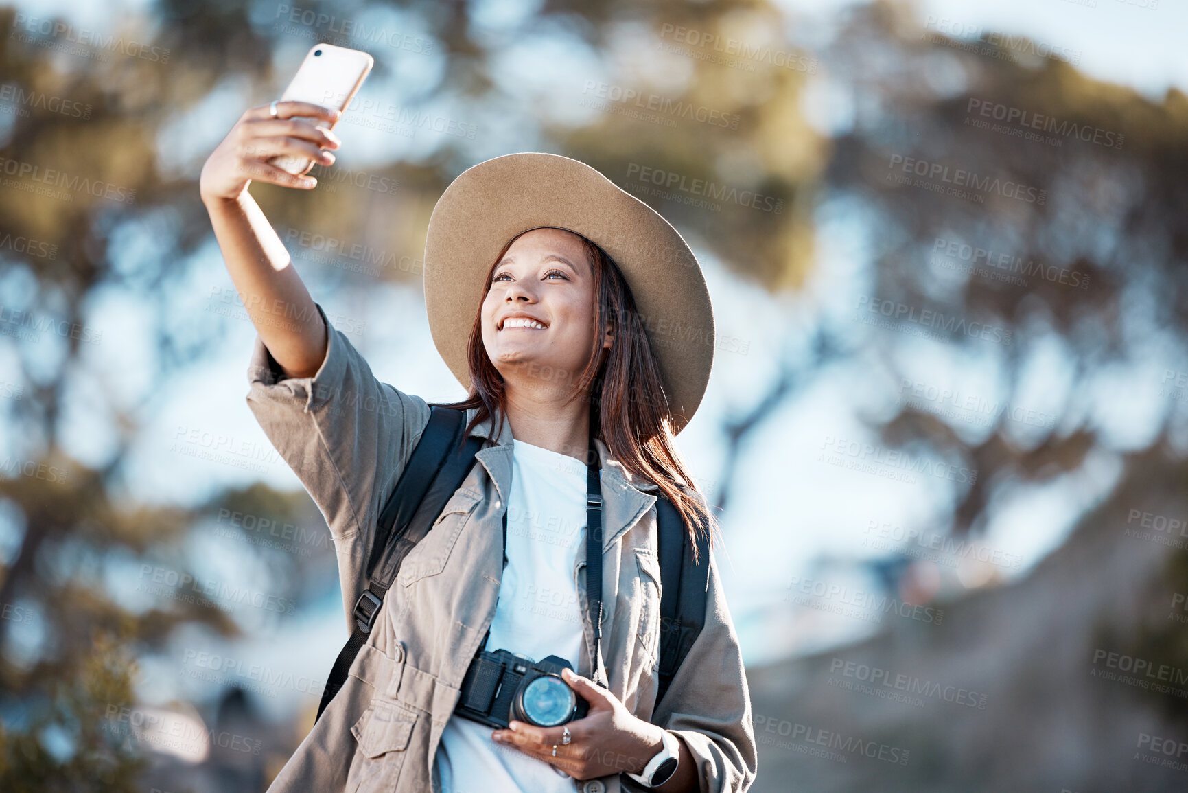 Buy stock photo Woman, tourist and smile for travel selfie on hiking adventure, backpacking journey or profile picture in nature. Female hiker smiling for photography, memory photo or scenery in mountain trekking