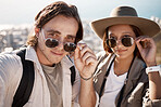 Selfie, hiking and couple on vacation, adventure and wellness with fitness, romance and cheerful. Portrait, romantic man and woman with sunglasses, hikers or journey for summer holiday, break or love