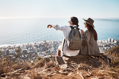 Buy stock photo Pointing, view and couple on a mountain for hiking, travel and trekking in Switzerland. Relax, adventure and man and woman sitting on a cliff looking at the city from nature while on vacation