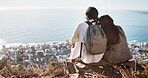 Couple, travel and cityscape with ocean view for peace and calm while hiking with a backpack. Man and woman together on vacation in nature with love, care and support with a hug outdoor on mountain