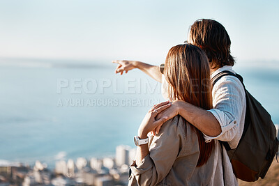 Buy stock photo Travel, pointing and hiking with couple on mountains with mockup for adventure, relax and summer. Fitness, nature and ocean view with man and woman hugging for affectionate, bonding and vacation