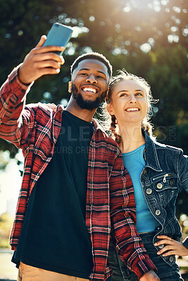Buy stock photo Selfie, love and happy couple on an outdoor date for their anniversary or romance together. Happiness, smile and interracial man and woman taking picture on a phone while on a walk in park in nature.