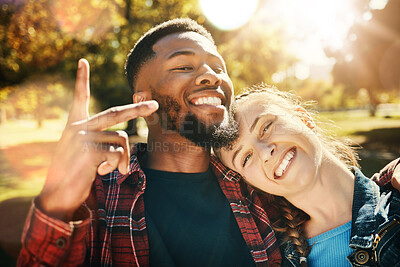 Buy stock photo Couple smile, selfie peace sign and portrait outdoors, enjoying fun time and bonding at park. Interracial, love romance and black man and woman with v hand emoji for taking pictures for happy memory.