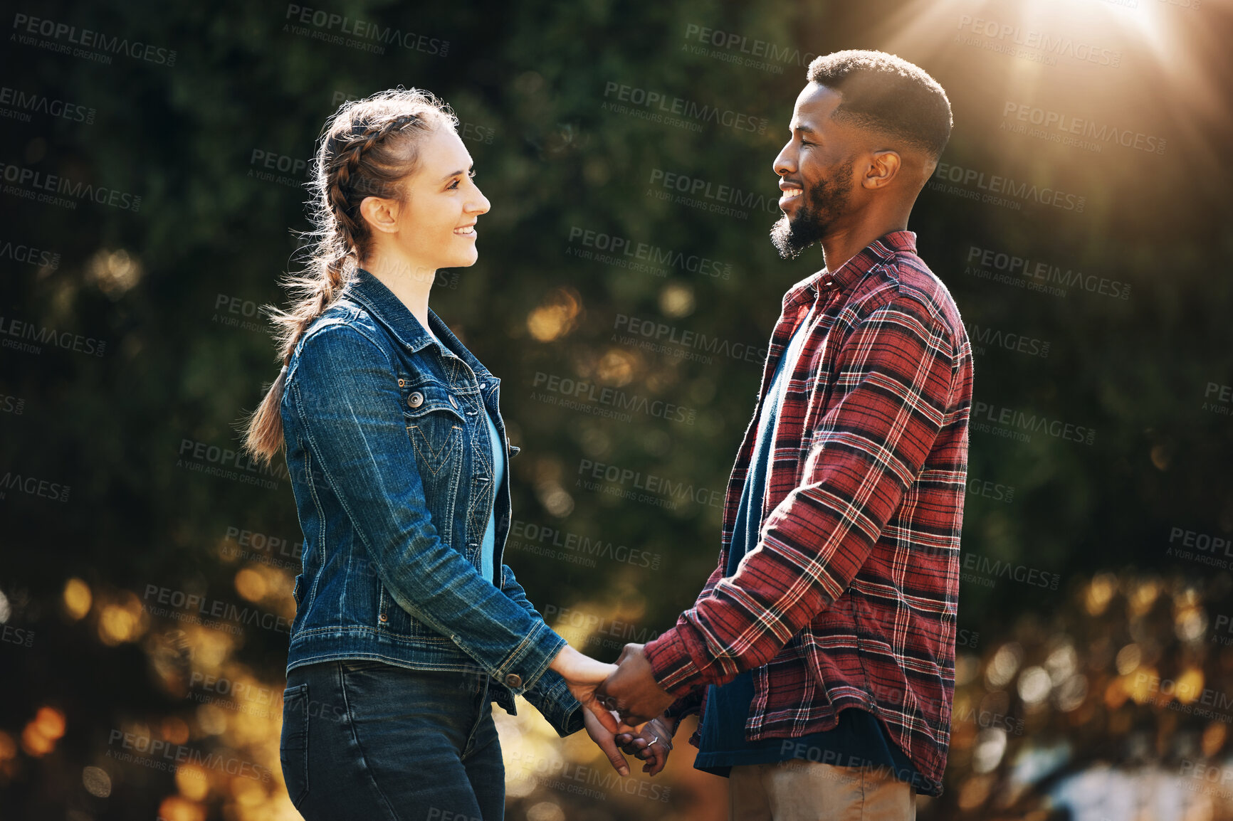 Buy stock photo Love, date and interracial couple holding hands in nature for a walk, romamce and gratitude. Support, trust and black man with a woman, affection and walking in marriage in a park in Germany