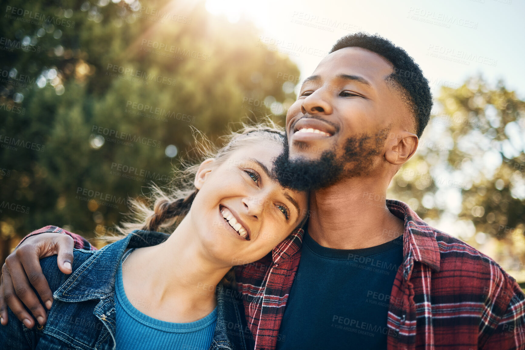 Buy stock photo Young couple hug in park, summer and outdoor date together in sunshine, happiness and nature. Happy man hugging woman in garden for love, care and support with diversity partner, relax and smile face