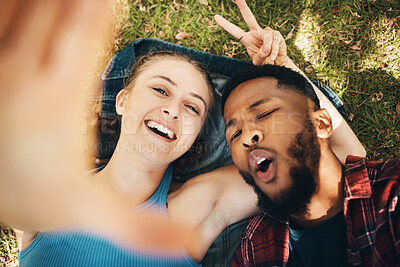 Buy stock photo Peace sign selfie, couple and portrait smile at park outdoors, laughing at comic joke and bonding. Diversity, love romance and black man and woman with v hand emoji to take photo for happy memory.
