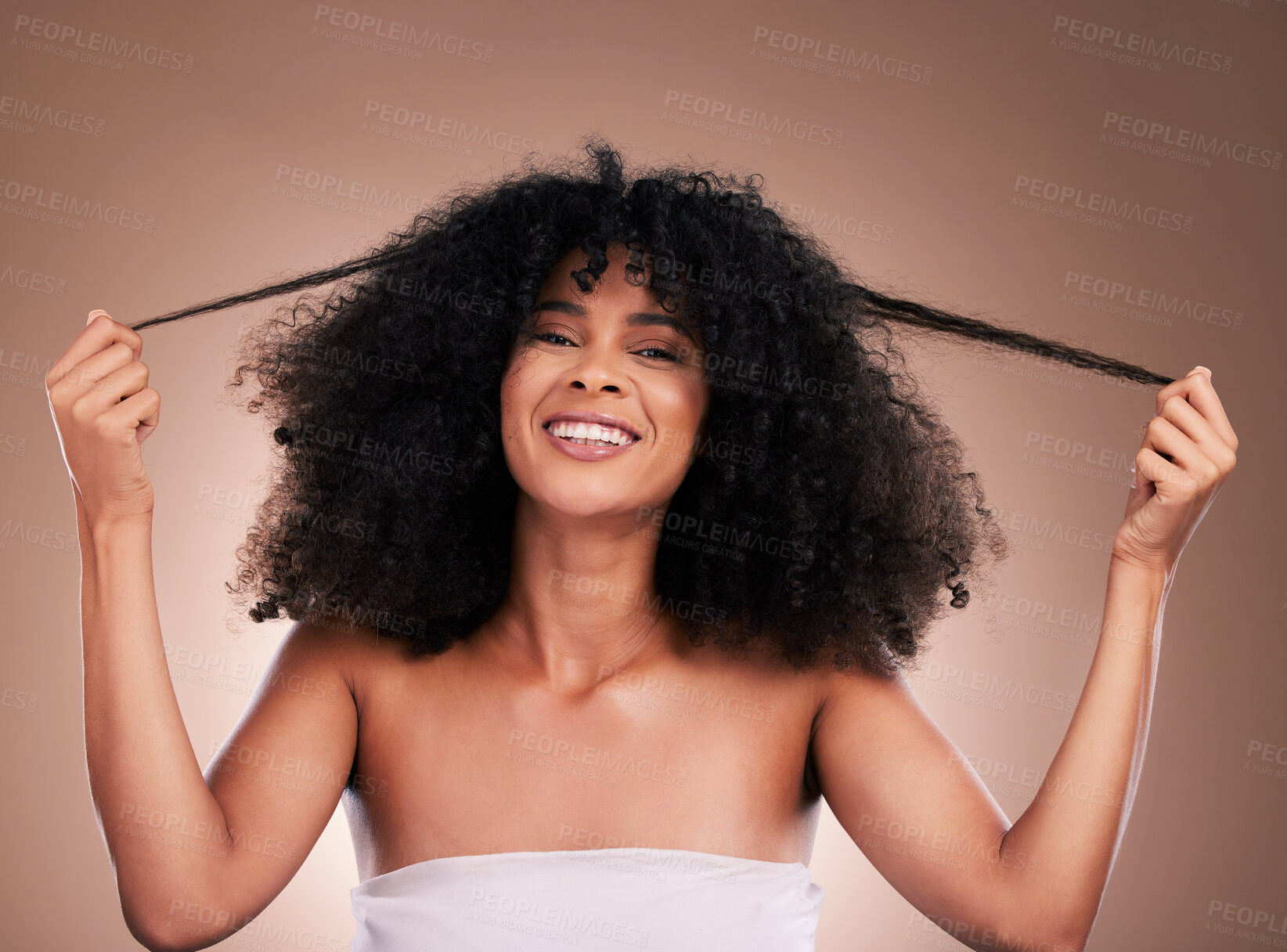 Buy stock photo Hair in hands, beauty and portrait of black woman on brown background for wellness, shine and natural glow. Salon, luxury treatment and happy girl face with curly hairstyle, texture and afro growth