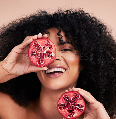 Buy stock photo Black woman, studio portrait and pomegranate with smile, beauty and skincare for health, wellness and diet. Happy gen z model, african and fruit for aesthetic, healthy nutrition or glow by background