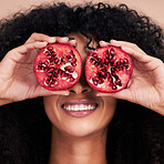 Hair care, face and black woman with pomegranate in studio isolated on a brown background. Fruit, skincare and happy female model holding food for healthy diet, nutrition or vitamin c and minerals.