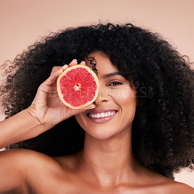 Buy stock photo Face, hair care and portrait of black woman with grapefruit in studio isolated on a brown background. Fruit, skincare and happy female model holding food for healthy diet, nutrition and vitamin c.