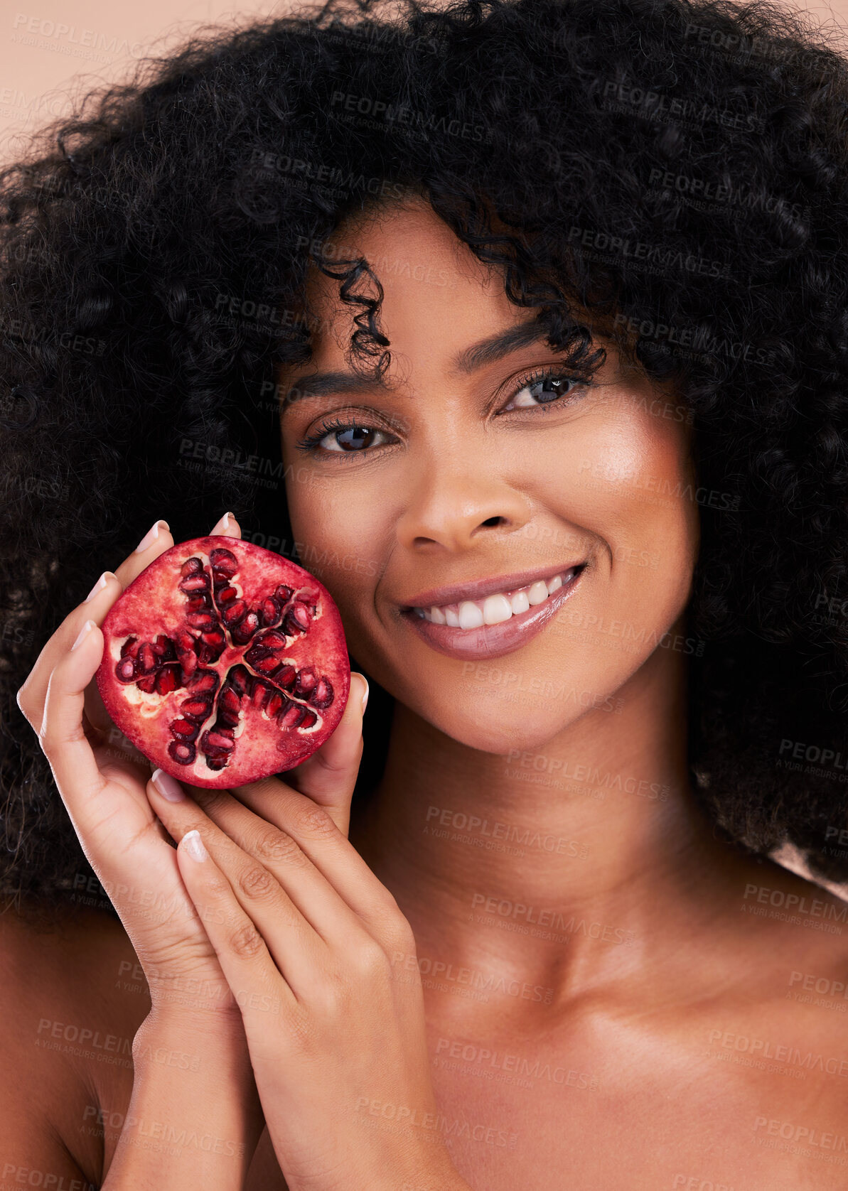 Buy stock photo Face, hair care and portrait of black woman with pomegranate in studio isolated on a brown background. Fruit, skincare and happy female model holding food for healthy diet, nutrition and vitamin c.