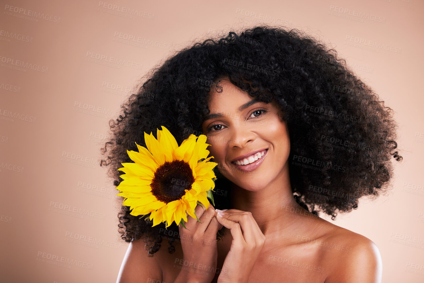 Buy stock photo Black woman, studio portrait and sunflower with smile, beauty and cosmetic wellness by beige background. African gen z model, flower and spring aesthetic with happiness, makeup and natural makeup