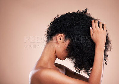Buy stock photo Hair care, touching and a woman styling curls isolated on a brown background in a studio. Salon, cosmetic and model feeling a hairstyle for volume, touchup and style for an afro on a backdrop