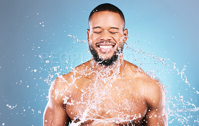 Buy stock photo Shower, athlete and water splash for black man cleaning, hygiene and skincare isolated in studio blue background. Portrait, aqua and model with washing smooth skin with glow smile closed eyes