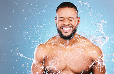 Buy stock photo Shower, beauty and water splash for man cleaning, hygiene and skincare isolated in studio blue background. Happy, aqua and model washing smooth skin with glow smile, closed eyes and mockup