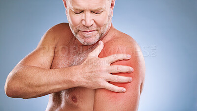 Senior man, arm pain and red glow on muscle or body on a blue background in studio with arthritis. Elderly model person with hand on injury, anatomy health problem or broken bone medical risk