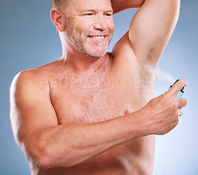 Buy stock photo Man, armpit and spray in skincare hygiene, grooming or smelling fresh against a studio background. Elderly male smiling and spraying deodorant under arms in satisfaction for aroma or clean cosmetics