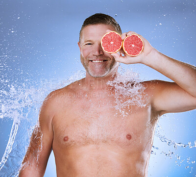 Buy stock photo Grapefruit in hand, water and man with face, beauty and skincare, eco friendly and organic on studio background. Hydration, vitamin c and hygiene, senior male in portrait, smile and citrus fruit