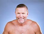 Facial, man smile and portrait of a mature beauty model in a blue background studio with mockup. Skincare, cosmetics wellness and spa treatment of a senior person with happiness from self care glow