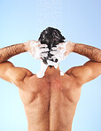 Shower, cleaning hair and back of man with shampoo, conditioner and water splash for wellness. Self care, bathroom hygiene and male with foam, grooming products and washing body on blue background