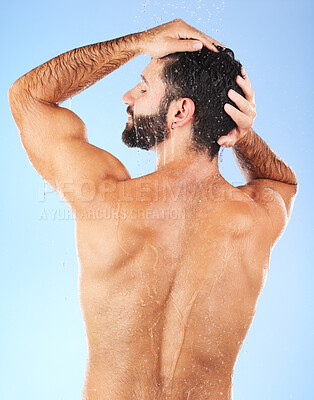 Buy stock photo Water, shower and back of man in studio for skincare, wellness and shampoo cosmetics on blue background. Hair, body and male model cleaning with water, beauty and dermatology on bathroom backdrop 