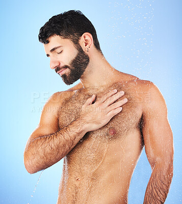 Buy stock photo Body care, shower and man in studio for wellness, hygiene and skincare against blue background. Cleaning, chest and male model relax in luxury, water splash and beauty routine isolated in a bathroom