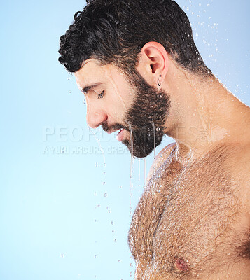 Buy stock photo Man, water and profile of a model in shower for cleaning, skincare and hygiene wellness. Isolated, blue background and studio with a young person in bathroom for facial dermatology and mockup
