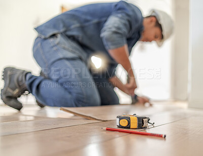 Buy stock photo Construction worker tape measure, wood carpenter and home floor renovation of a builder. Working, woodwork and handcraft of a manufacturing, building and house maintenance development of an artisan