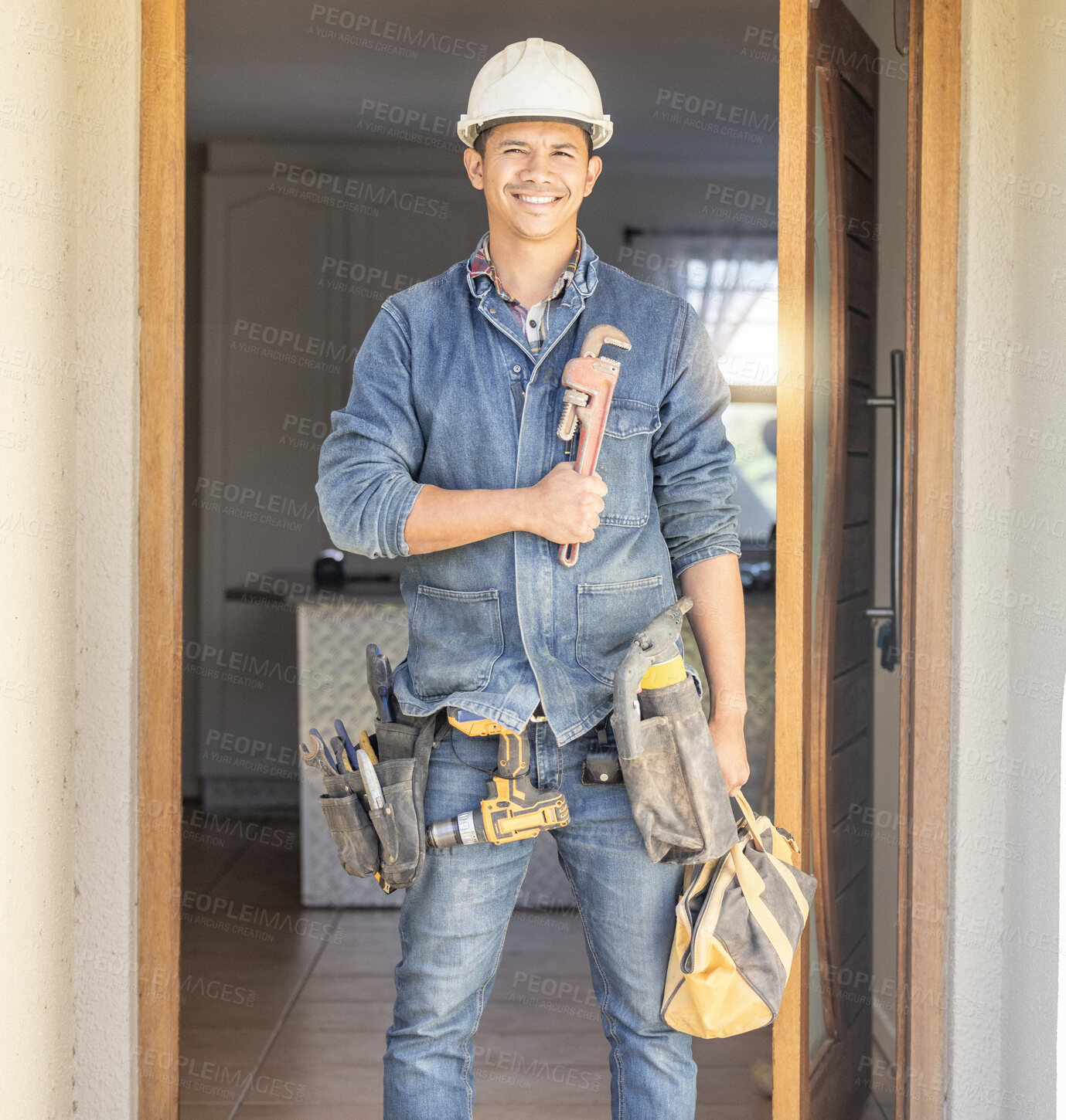 Buy stock photo Handyman in portrait, maintenance job and tools with construction and home renovation, builder with smile. Professional contractor, DIY skills and manual work with wrench, male with helmet for safety