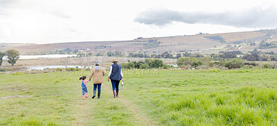 Buy stock photo Agriculture, field in countryside with family walking on farm and back view, green and sustainability with agro. Fresh air, farming and farmer with people outdoor, holding hands and environment