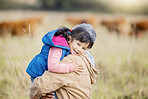 Grandmother carrying girl, field portrait and family farm, grass and bonding together with love outdoor. Old woman, child and hug support in countryside, care and happiness in nature with landscape