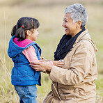 Grandmother, happy girl and family love of a kid with senior woman in the countryside. Outdoor field, grass and elderly female with child on a on vacation with happiness, care and fun in nature
