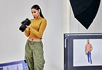 Serious, photographer and woman with camera in studio for shoot, magazine project or online content. Backstage, focus or girl thinking for digital profession, fashion design or creative career