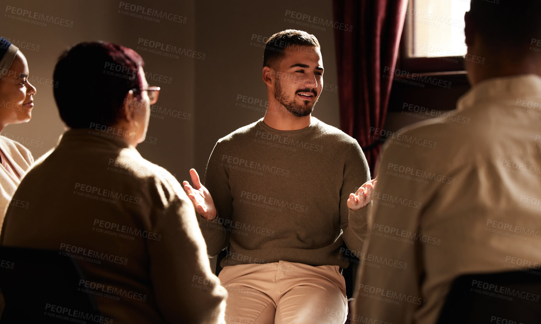 Buy stock photo Support, smile and man sharing in group therapy with understanding, feelings and talking in session. Mental health, addiction or depression, men and women with therapist sitting together for healing.