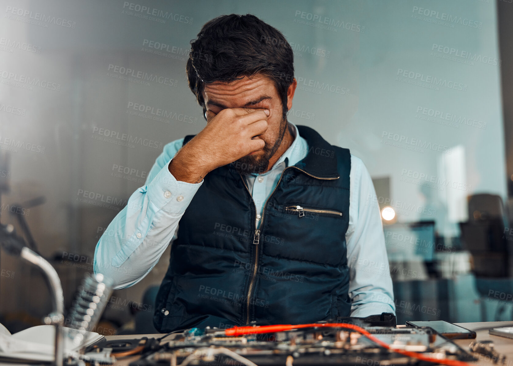 Buy stock photo Tired, headache and man in technology repair, service and maintenance of electronic devices. Anxiety, migraine and technician with a problem, frustrated and stress while building electronics