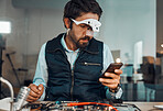 Chat, phone and man working in technology repair, technician workshop and engineeering. Communication, broken and serious handyman reading on a mobile online to fix an electronic appliance at work