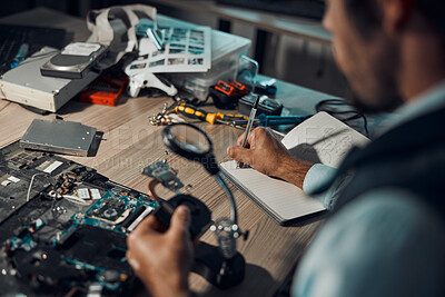 Buy stock photo Technician, engineer or IT man repair motherboard, circuit board or electronic device in workshop or office at night. Person, startup and guy writing hardware notes for  computer or technology in lab