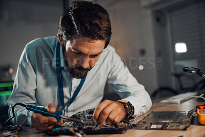 Buy stock photo Concentration man, it or soldering motherboard in engineering workshop for night database fixing. Technician, circuit board or tools in repair, maintenance upgrade or information technology industry