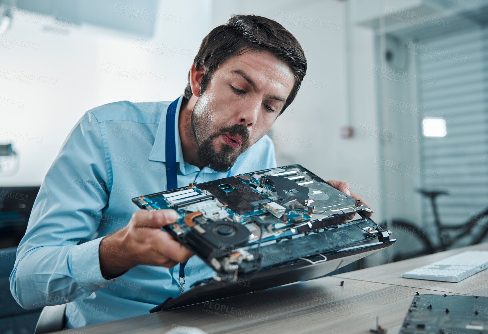 Buy stock photo Information technology, laptop circuit repair and man blow hardware dust, electronics or semiconductor. CPU system maintenance, service industry and IT worker fixing motherboard microchip in tech lab