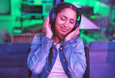 Buy stock photo Music headphones, relax and woman in home streaming radio or podcast at night in green neon light. Hacker, it programmer and happy female coder listening and enjoying song, audio or sound in house.