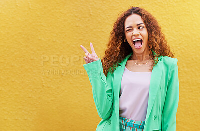 Buy stock photo Woman, peace and wink on yellow background, color backdrop and mockup space. Happy female, v sign and hands of cool model for victory, winking and fun mood with happiness, mock up and gen z fashion