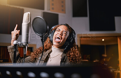 Buy stock photo Music, singing and radio with a black woman celebrity at her record label to sing a song for her new album. Creative, art and performance with a female singer streaming live in a recording studio