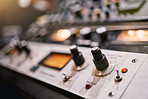 Music, studio and equipment in an empty booth for recording or live streaming a broadcast on the radio closeup.  Media, technology and production with an electronic soundboard for mixing audio