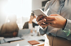 Business woman typing, phone text and meeting with a female employee on a mobile app. Office, corporate team and online chat of a financial analytics worker on a cellphone with blurred background