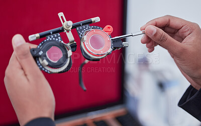 Buy stock photo Hands, trial frame and optometry, lens and test, vision and glasses with ophthalmologist tools, healthcare for eyes. Optometry, eye care and optometrist person, medicine and chart with measurement