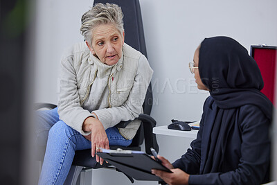 Buy stock photo Optometry, consulting and woman with an optician for paperwork, medical background and communication. Healthcare, ophthalmology and senior patient with a Muslim doctor for information on eyesight