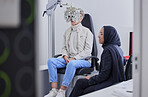 Vision, eye exam and senior woman with optometrist in clinic for testing, eyesight and optical assessment. Optometry, healthcare and Muslim optician with patient, phoropter and medical tool for eyes