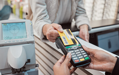 Buy stock photo Hands, credit card and machine for payment, ecommerce or banking transaction at clinic or store. Hand of customer tapping debit in transact for purchase, electronic pay or POS at optometry shop