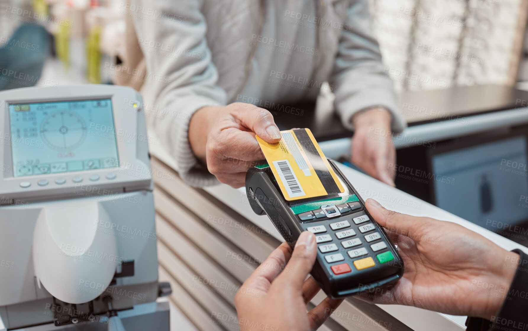 Buy stock photo Hands, credit card and machine for payment, ecommerce or banking transaction at clinic or store. Hand of customer tapping debit in transact for purchase, electronic pay or POS at optometry shop